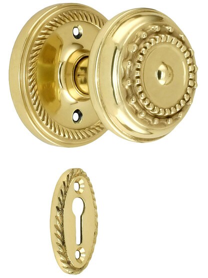 Rope Rosette Style Mortise Lock Set With Meadows Door Knobs in Polished Brass finish.